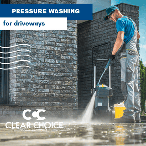 man pressure washing a driveway