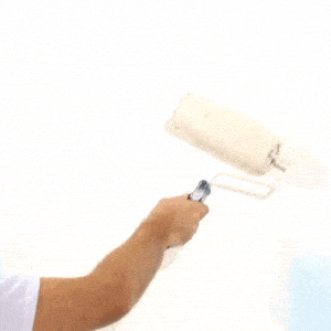 paint roller going over white wall